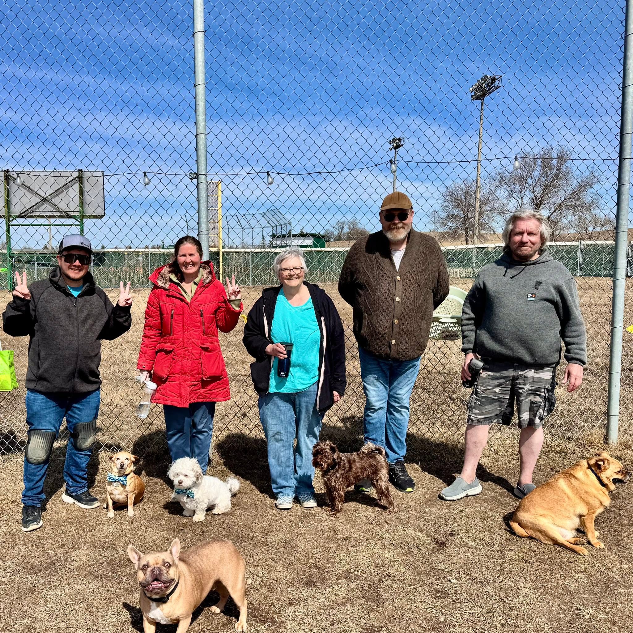 Dog park users and volunteers gathered after a cleanup at a Regina off-leash dog park